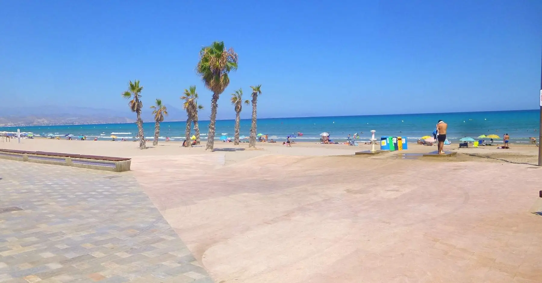 The beach at Playa de San Juan, with the apartment blocks of the seafront behind it.